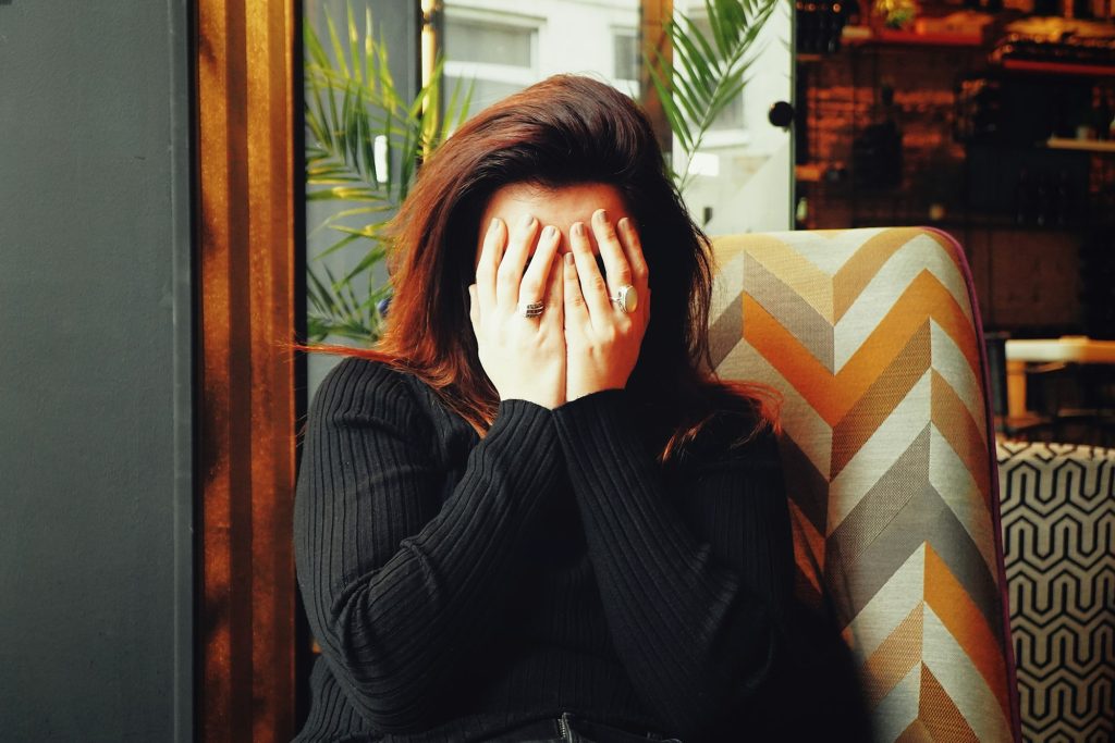 Person holding their head and temple, showing tension headache pain