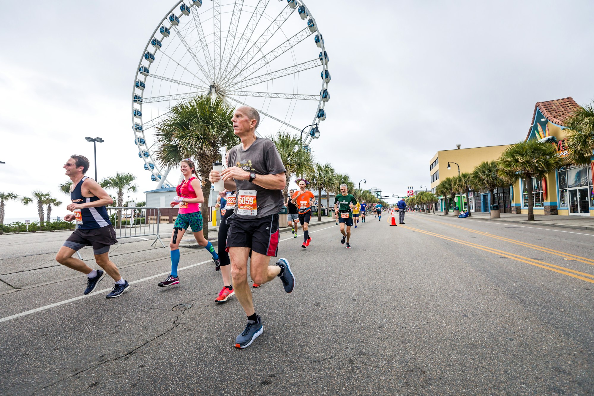 Runner in mid-stride during a race, hip and knee driving forward