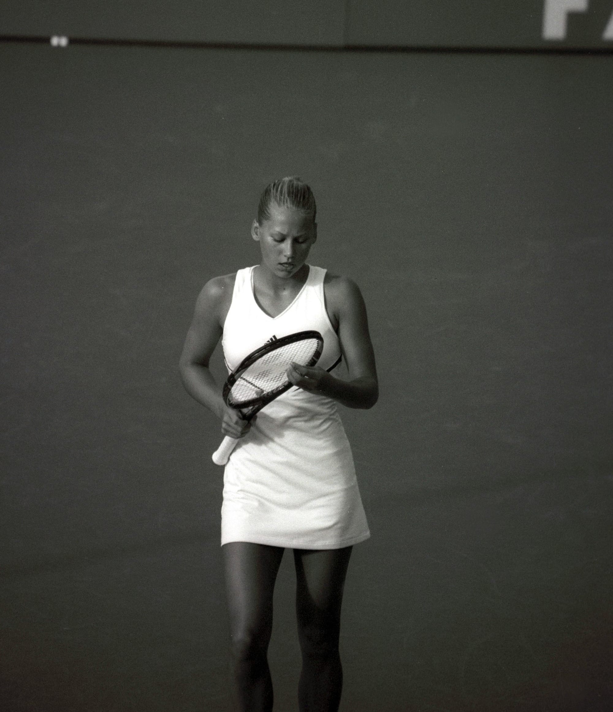 Athlete standing with a tennis racket, ready to play