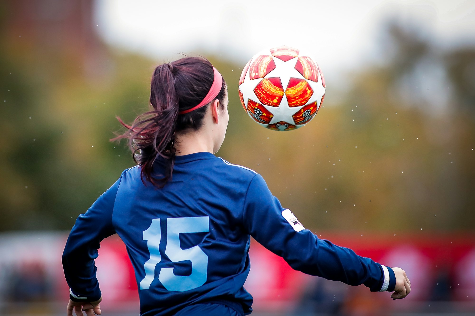 Young soccer player dribbling a ball during training